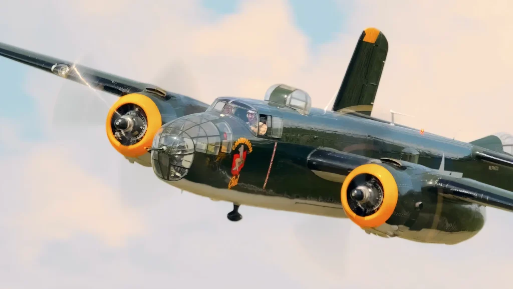 B-25 Champaign Gal flying at the 2024 Lake Cumberland Kentucky Air Show against a backdrop of partly cloudy skies.